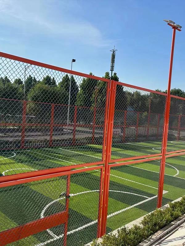Artificial grass football field in mesh fences
