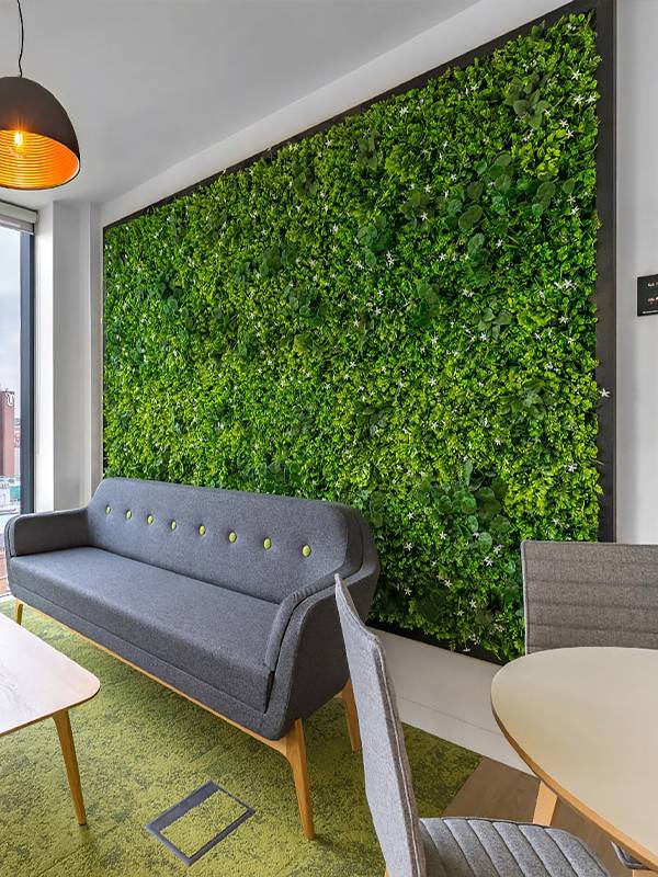 Artificial plant wall is placed in the living room.