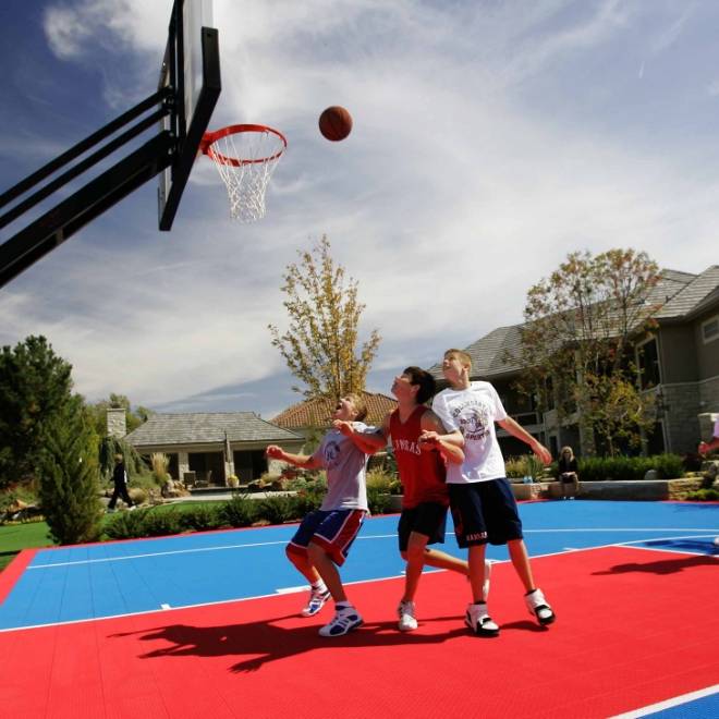 Players are playing the basketball on artificial turf.