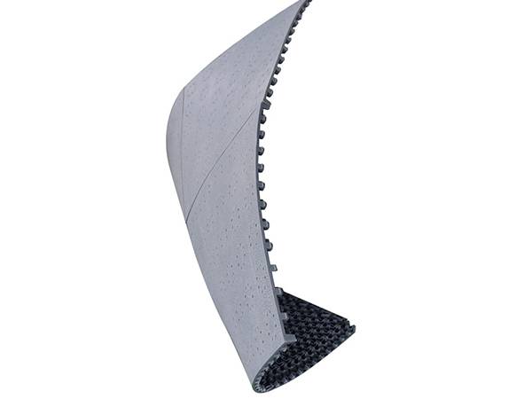 A piece of interlocking sports flooring tile is folding without deformation.