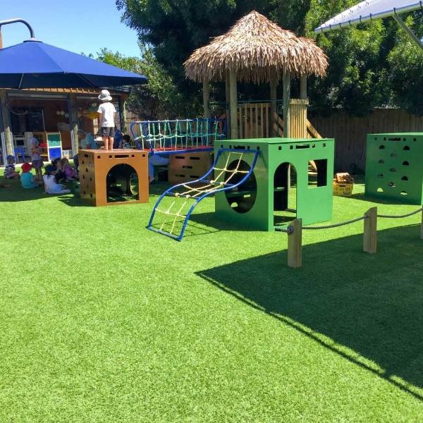 Kindergarten yard is laid with artificial grass.