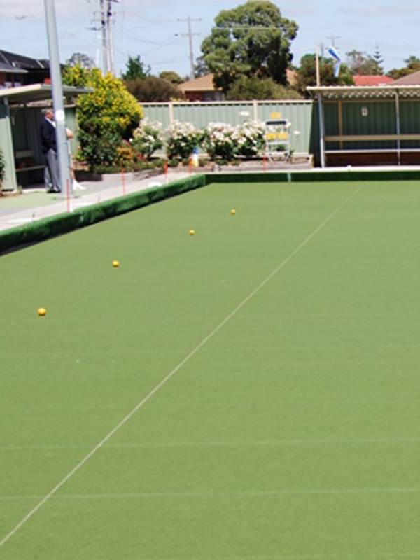 Lawn bowls artificial turf with several lawn bowls