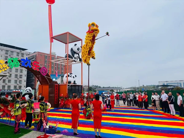 A lion dancing on a colorful meadow celebrates the opening of Longchuan Panda Playground