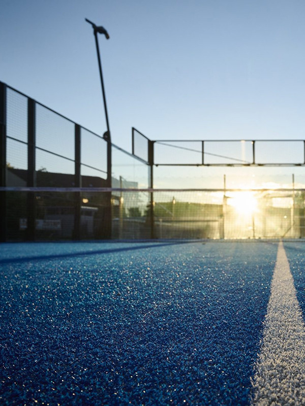 Panoramic padel court with blue artificial grass from a bird's eye view