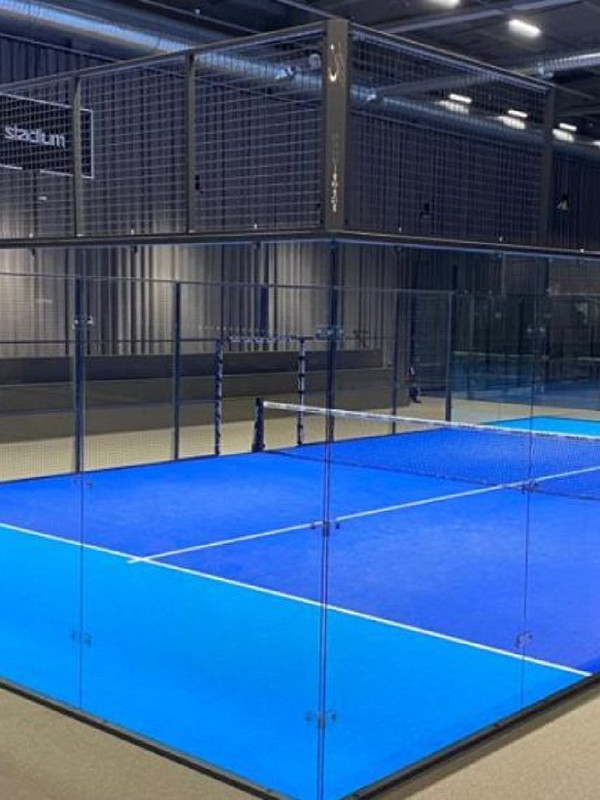 Side view of an indoor panoramic padel court