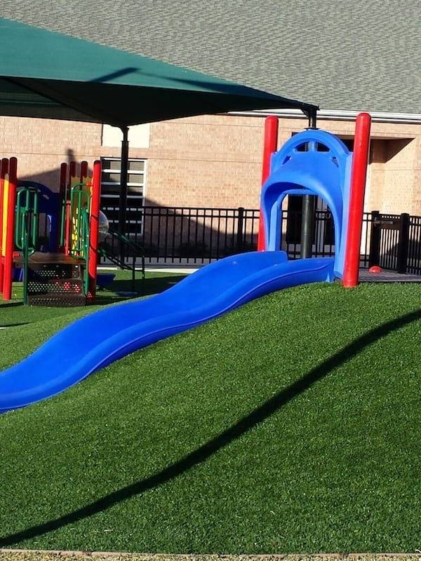Playground artificial turf is placed on a slope.