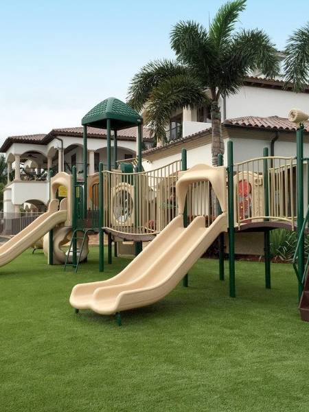 2 slides are placed on playground artificial turf.