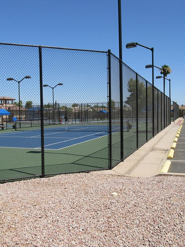 Installation of multiple fences around the tennis court for protection