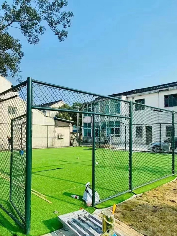 Sports field fencing with green lawn