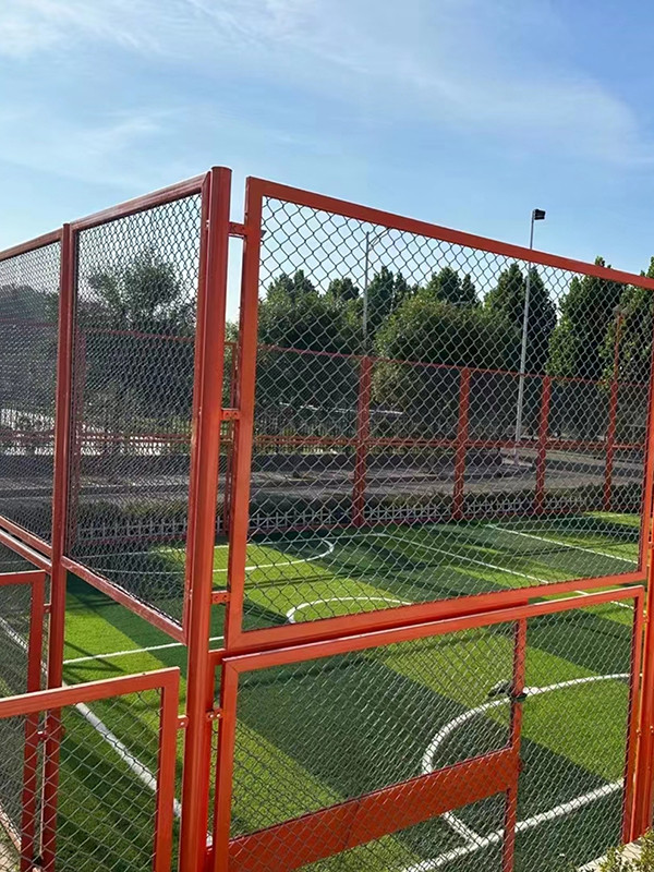 The stadium surrounded with orange frame fencing for safety protection