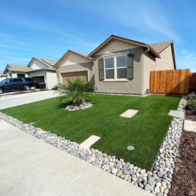 Residential landscape artificial turf in front of the house.